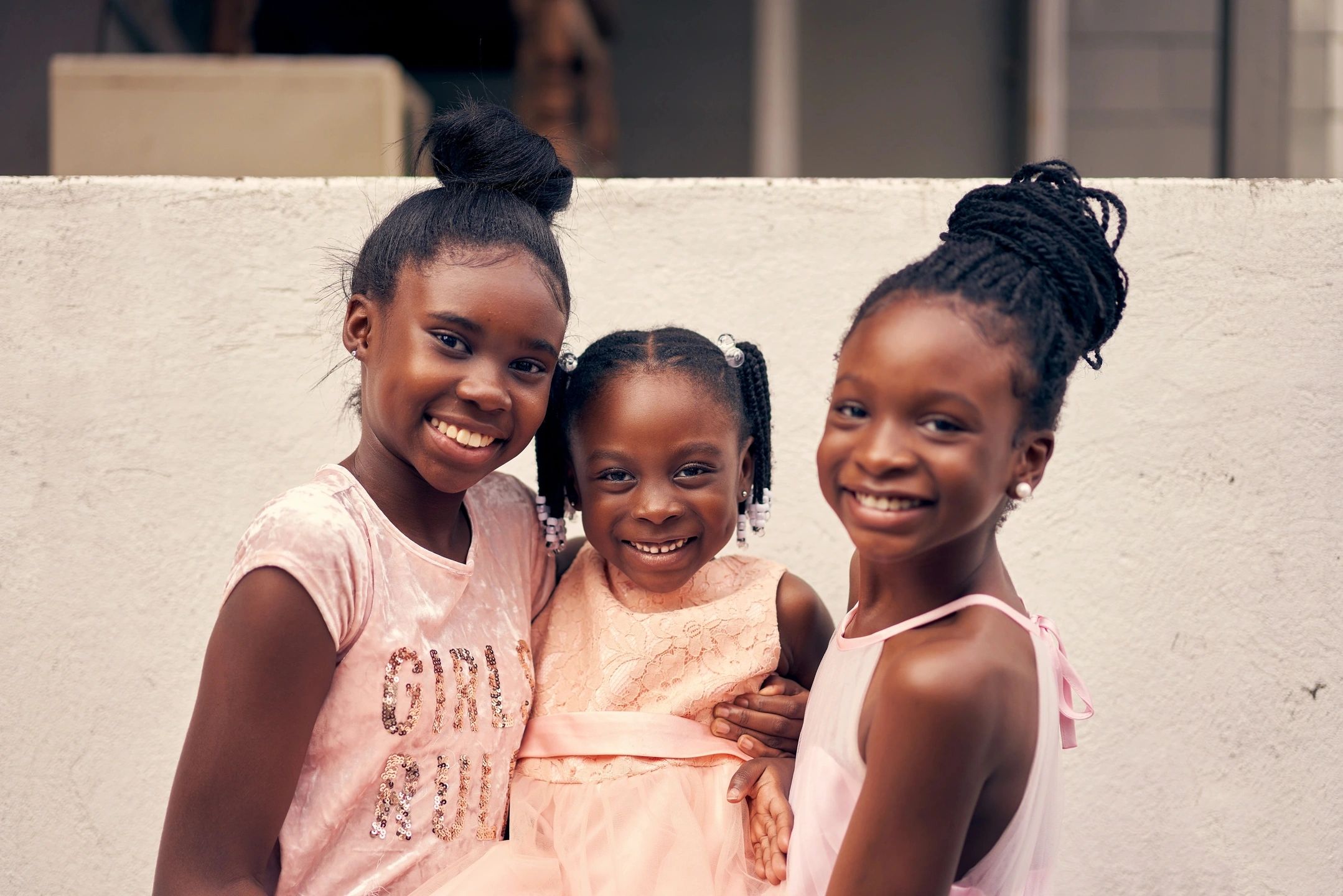 Three young girls smiling